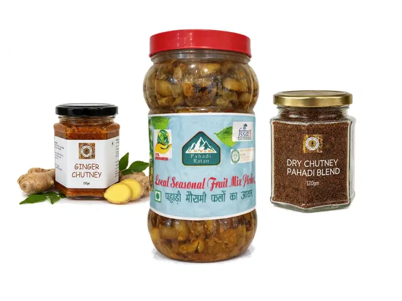 Indian pickle jars and ingredients arranged on a table